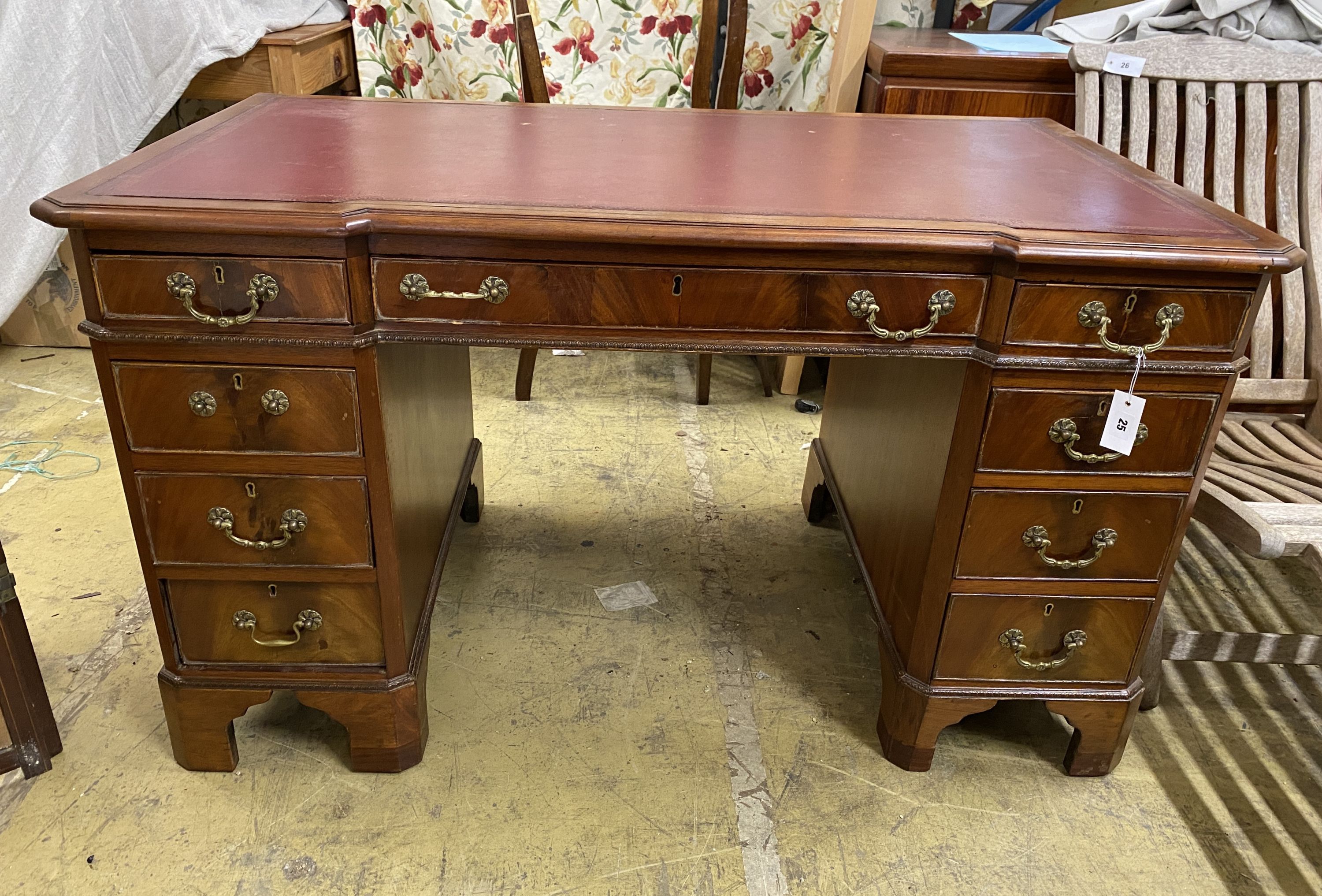 A mahogany breakfront pedestal desk, width 135cm